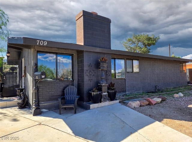 709 Evergreen Cir, Las Vegas, NV 89107 - back of property with a chimney and a patio