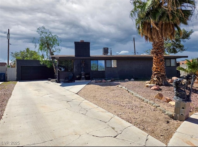 709 Evergreen Cir, Las Vegas, NV 89107 - view of front of property with an attached garage, a chimney, and driveway