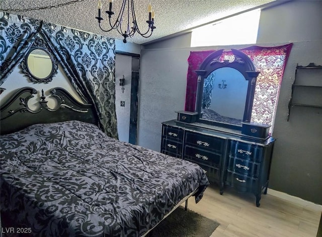 709 Evergreen Cir, Las Vegas, NV 89107 - bedroom featuring wood finished floors, a chandelier, a textured ceiling, and lofted ceiling
