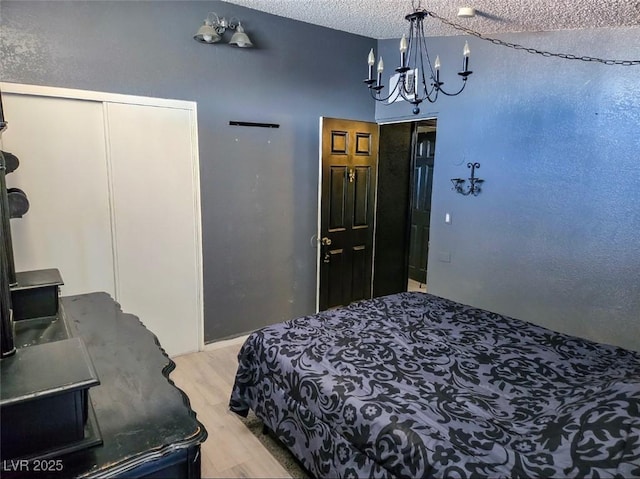 709 Evergreen Cir, Las Vegas, NV 89107 - bedroom featuring light wood finished floors and a chandelier
