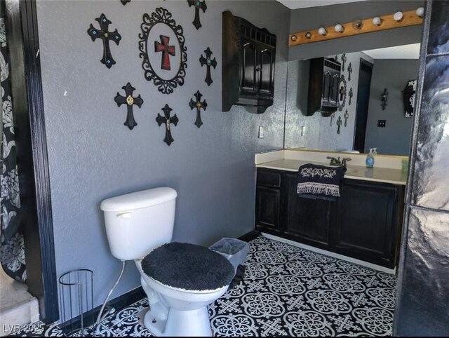 709 Evergreen Cir, Las Vegas, NV 89107 - bathroom with vanity, toilet, and baseboards