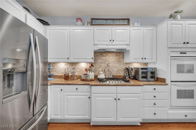 10213 Treasure Mountain Ct, Las Vegas, NV 89129 - kitchen with stainless steel appliances, under cabinet range hood, and white cabinetry