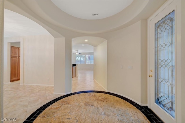 11441 Drappo Ave, Las Vegas, NV 89138 - foyer featuring arched walkways, a ceiling fan, light tile patterned flooring, baseboards, and inlaid floor details