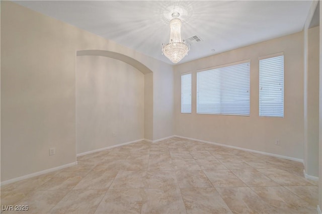 11441 Drappo Ave, Las Vegas, NV 89138 - spare room featuring a chandelier, arched walkways, baseboards, and light tile patterned flooring