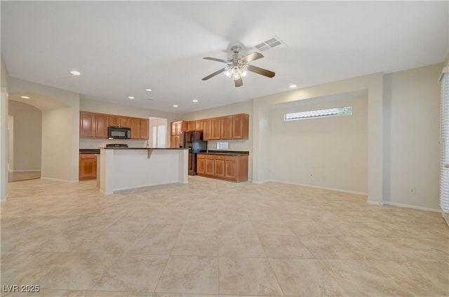 11441 Drappo Ave, Las Vegas, NV 89138 - kitchen with black appliances, open floor plan, dark countertops, ceiling fan, and recessed lighting