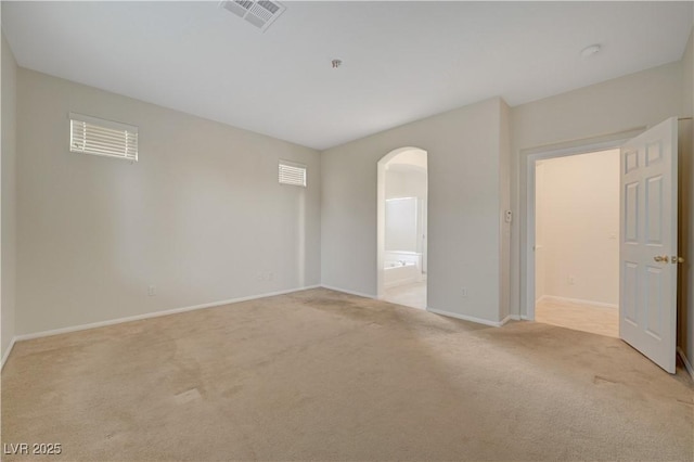 11441 Drappo Ave, Las Vegas, NV 89138 - empty room featuring arched walkways, light colored carpet, and baseboards
