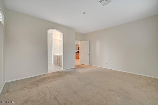 11441 Drappo Ave, Las Vegas, NV 89138 - unfurnished room featuring light carpet, arched walkways, and baseboards