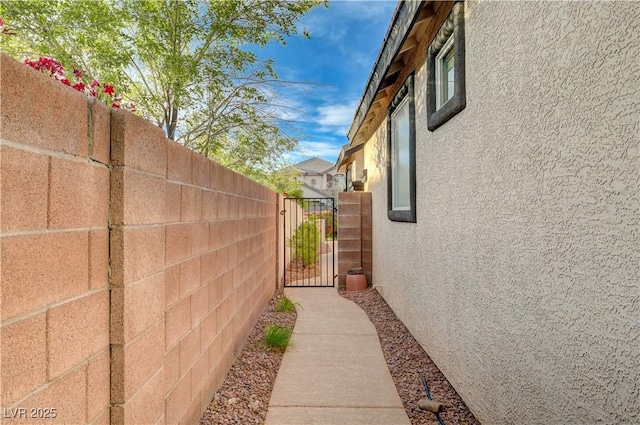 11441 Drappo Ave, Las Vegas, NV 89138 - view of side of home featuring stucco siding and a gate