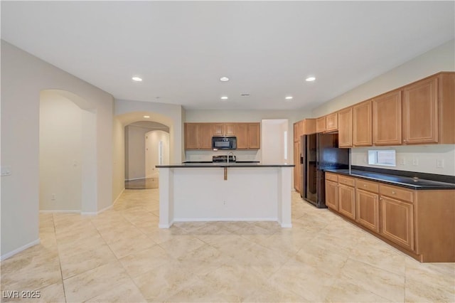 11441 Drappo Ave, Las Vegas, NV 89138 - kitchen with black appliances, arched walkways, dark countertops, recessed lighting, and baseboards
