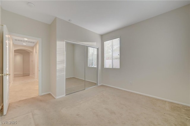 11441 Drappo Ave, Las Vegas, NV 89138 - unfurnished bedroom featuring arched walkways, carpet, baseboards, and a closet