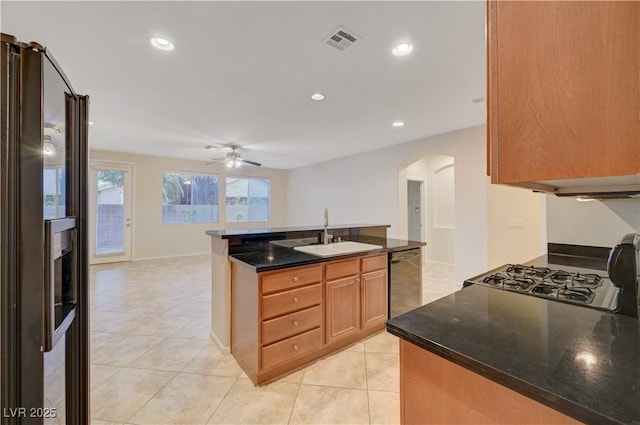 11441 Drappo Ave, Las Vegas, NV 89138 - kitchen with arched walkways, stainless steel fridge, ceiling fan, a sink, and black dishwasher