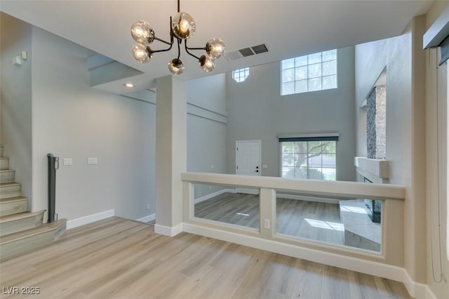 10908 Royal Highlands St, Las Vegas, NV 89141 - unfurnished dining area featuring healthy amount of natural light, a chandelier, wood finished floors, and baseboards
