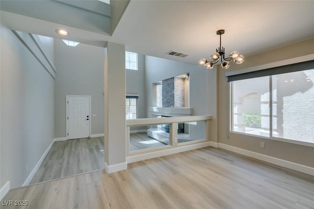 10908 Royal Highlands St, Las Vegas, NV 89141 - foyer entrance featuring a chandelier, wood finished floors, healthy amount of natural light, and baseboards