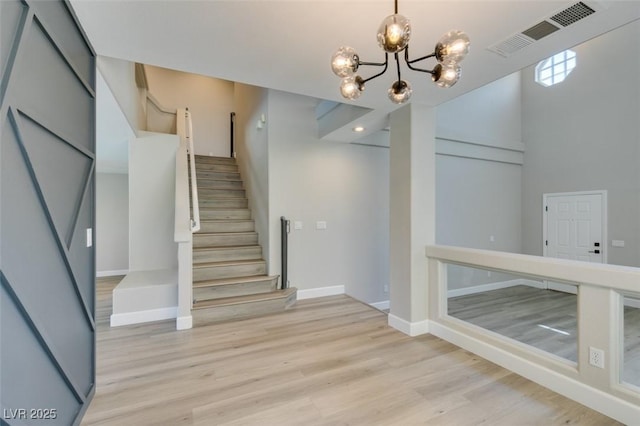 10908 Royal Highlands St, Las Vegas, NV 89141 - stairs featuring a chandelier, wood finished floors, and baseboards
