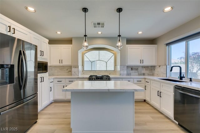 10908 Royal Highlands St, Las Vegas, NV 89141 - kitchen with appliances with stainless steel finishes, a sink, a center island, white cabinetry, and recessed lighting