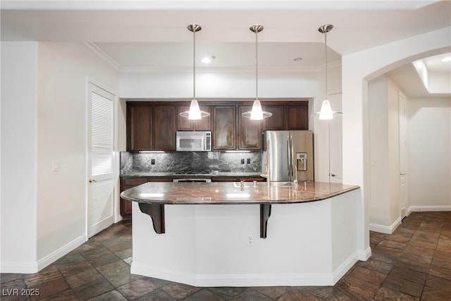 68 E Serene Ave Unit 224, Las Vegas, NV 89123 - kitchen featuring appliances with stainless steel finishes, stone tile flooring, arched walkways, baseboards, and ornamental molding