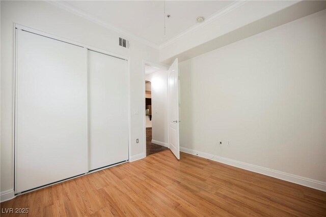 68 E Serene Ave Unit 224, Las Vegas, NV 89123 - unfurnished bedroom featuring ornamental molding, light wood-style flooring, a closet, and baseboards