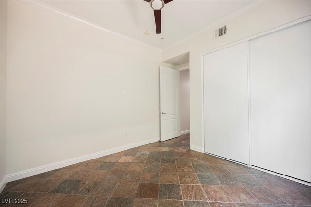 68 E Serene Ave Unit 224, Las Vegas, NV 89123 - unfurnished bedroom with stone finish floors, baseboards, crown molding, a closet, and ceiling fan