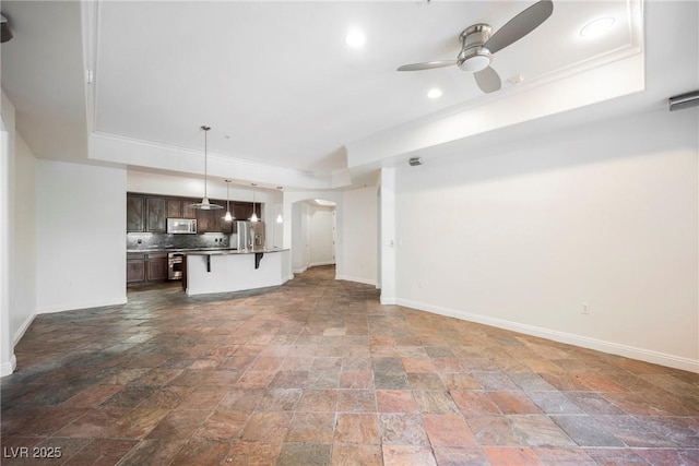 68 E Serene Ave Unit 224, Las Vegas, NV 89123 - unfurnished living room with a tray ceiling, ceiling fan, stone tile flooring, baseboards, and recessed lighting