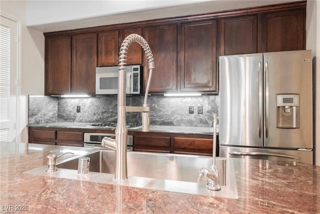 68 E Serene Ave Unit 224, Las Vegas, NV 89123 - kitchen featuring stainless steel appliances, light stone countertops, tasteful backsplash, and dark brown cabinets