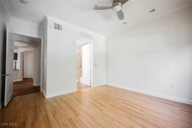 68 E Serene Ave Unit 224, Las Vegas, NV 89123 - empty room featuring arched walkways, ceiling fan, light wood-type flooring, crown molding, and baseboards