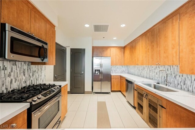 68 E Serene Ave Unit 224, Las Vegas, NV 89123 - kitchen with appliances with stainless steel finishes, a sink, brown cabinetry, and recessed lighting