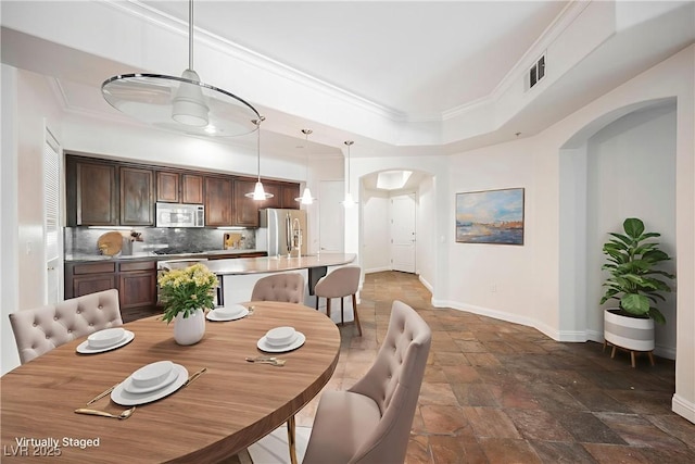 68 E Serene Ave Unit 224, Las Vegas, NV 89123 - dining space featuring arched walkways, stone tile flooring, baseboards, and crown molding