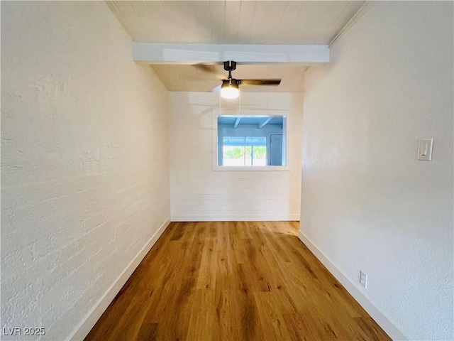 700 N Minnesota St, Las Vegas, NV 89107 - unfurnished room featuring wood finished floors, beam ceiling, baseboards, ceiling fan, and a textured wall