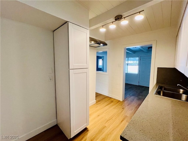 700 N Minnesota St, Las Vegas, NV 89107 - kitchen with a sink, white cabinets, light wood-type flooring, and baseboards