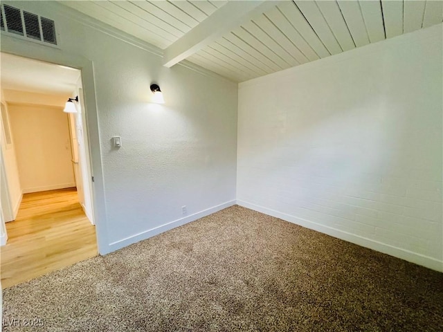 700 N Minnesota St, Las Vegas, NV 89107 - unfurnished room featuring light colored carpet, baseboards, and wood ceiling with exposed beams