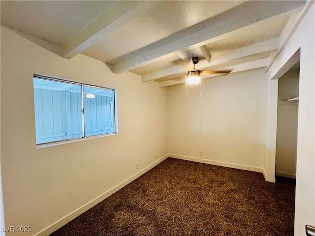 700 N Minnesota St, Las Vegas, NV 89107 - unfurnished bedroom featuring beamed ceiling, baseboards, dark carpet, and a ceiling fan
