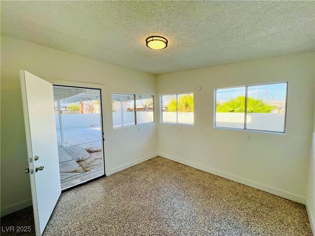 700 N Minnesota St, Las Vegas, NV 89107 - unfurnished room with a textured ceiling and baseboards