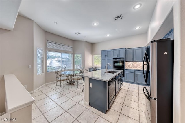 3050 Whispering Crest Dr, Henderson, NV 89052 - kitchen with freestanding refrigerator, a sink, backsplash, a center island with sink, and recessed lighting