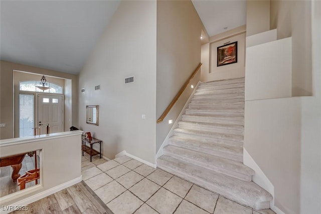 3050 Whispering Crest Dr, Henderson, NV 89052 - staircase with high vaulted ceiling and baseboards