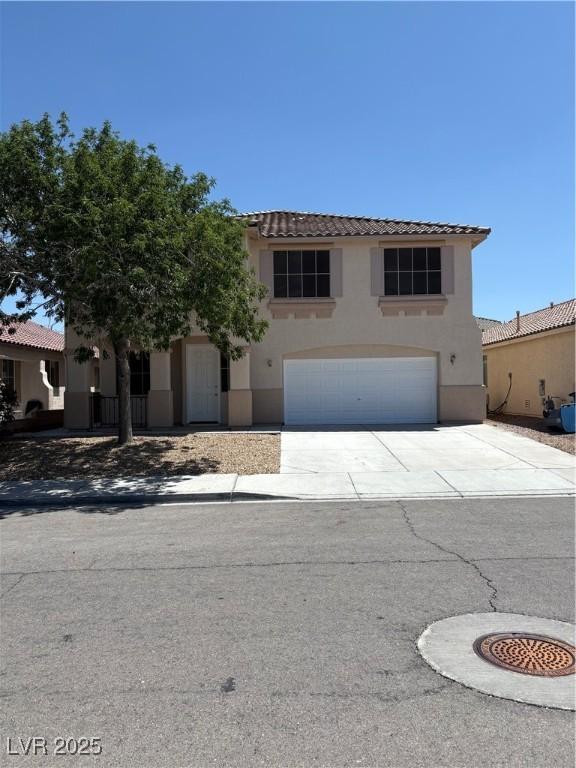 7615 Paso Robles Ave, Las Vegas, NV 89113 - mediterranean / spanish house featuring concrete driveway, stucco siding, a garage, and a tile roof