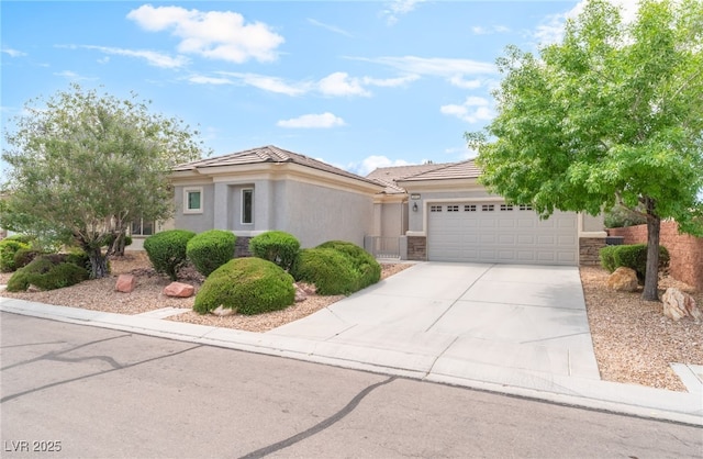 2413 Mourning Warbler Ave, North Las Vegas, NV 89084 - view of front of house with a garage, driveway, a tile roof, stucco siding, and stone siding