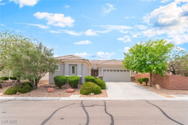 2413 Mourning Warbler Ave, North Las Vegas, NV 89084 - view of front of home with an attached garage, concrete driveway, stucco siding, and a tiled roof