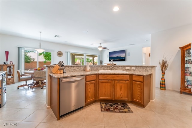 2413 Mourning Warbler Ave, North Las Vegas, NV 89084 - kitchen featuring dishwasher, a sink, a ceiling fan, brown cabinetry, and decorative light fixtures
