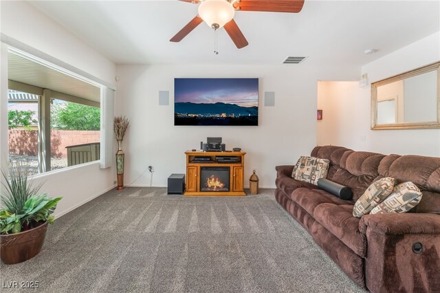 2413 Mourning Warbler Ave, North Las Vegas, NV 89084 - carpeted living area with a ceiling fan and baseboards