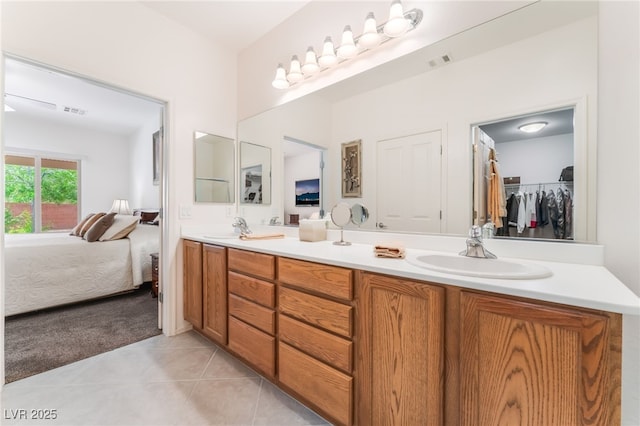2413 Mourning Warbler Ave, North Las Vegas, NV 89084 - ensuite bathroom featuring double vanity and tile patterned flooring