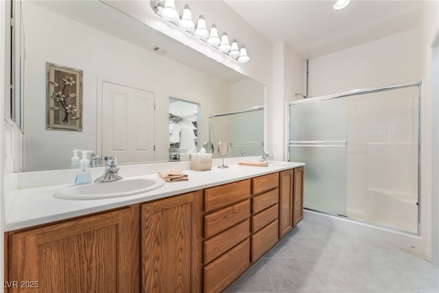 2413 Mourning Warbler Ave, North Las Vegas, NV 89084 - bathroom with double vanity, a shower stall, and tile patterned flooring