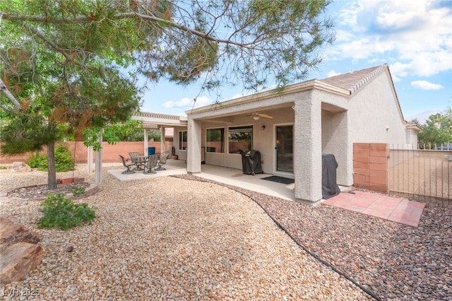 2413 Mourning Warbler Ave, North Las Vegas, NV 89084 - rear view of property featuring stucco siding, a ceiling fan, and a patio