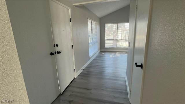 5720 Goldmount Ave, Las Vegas, NV 89107 - hallway with lofted ceiling, a textured wall, wood finished floors, and baseboards