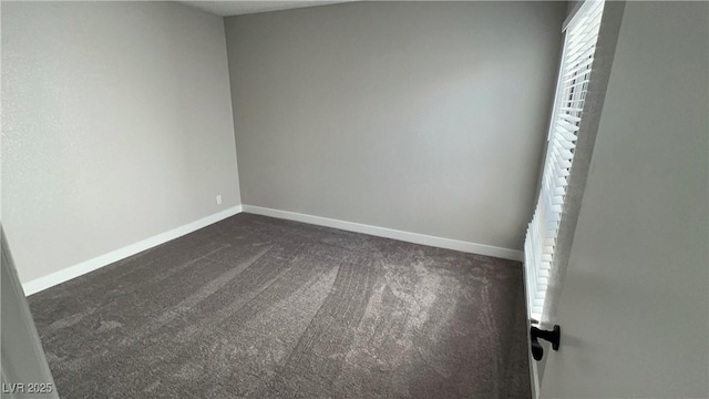 5720 Goldmount Ave, Las Vegas, NV 89107 - unfurnished room with dark carpet and baseboards