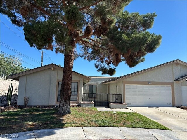 5720 Goldmount Ave, Las Vegas, NV 89107 - single story home with stucco siding, an attached garage, and driveway