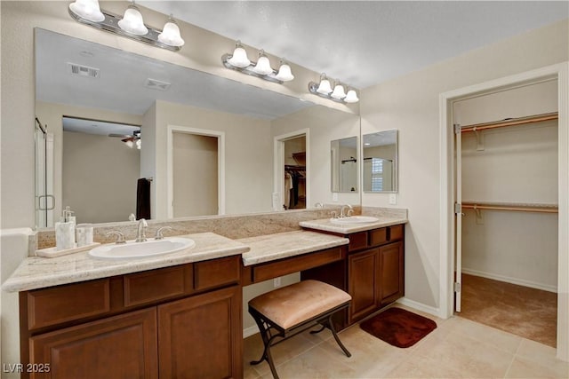 1560 Plaza Centre Dr Unit 103, Las Vegas, NV 89135 - full bathroom featuring double vanity, a walk in closet, and tile patterned floors