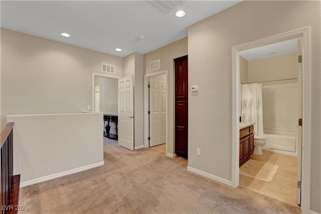 1560 Plaza Centre Dr Unit 103, Las Vegas, NV 89135 - corridor with light carpet, an upstairs landing, recessed lighting, and baseboards