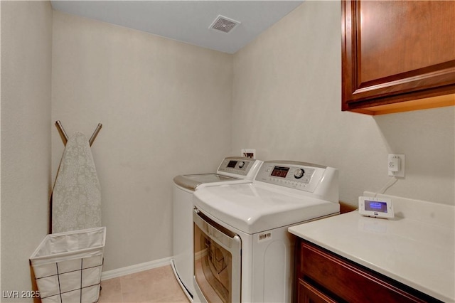 1560 Plaza Centre Dr Unit 103, Las Vegas, NV 89135 - washroom with cabinet space, washer and dryer, light tile patterned floors, and baseboards