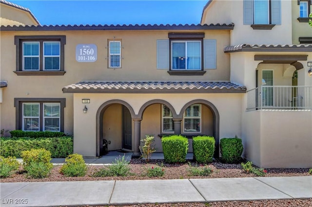 1560 Plaza Centre Dr Unit 103, Las Vegas, NV 89135 - view of front of home featuring stucco siding, a tile roof, and a porch