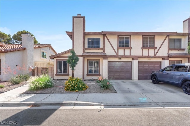110 Huckleberry Ln, Henderson, NV 89074 - view of front facade with driveway, an attached garage, stucco siding, and a chimney